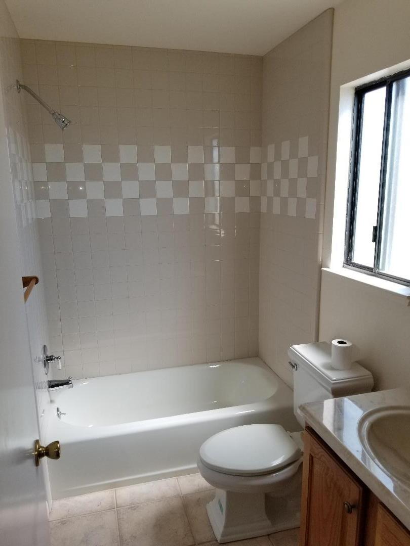 569 Powell Street Salinas, CA 93907 - Photo 13 of 14 a bathroom with a granite countertop toilet a sink and bathtub