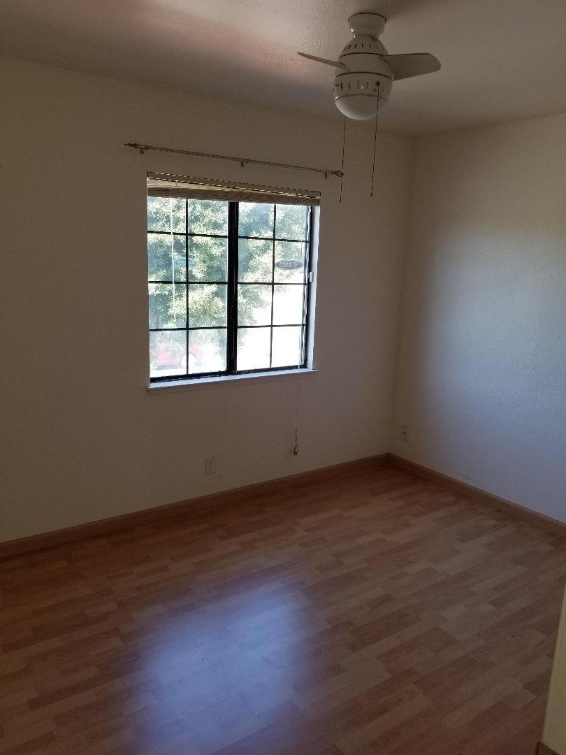569 Powell Street Salinas, CA 93907 - Photo 5 of 14 an empty room with wooden floor and windows