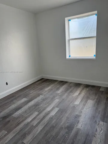 an empty room with wooden floor
