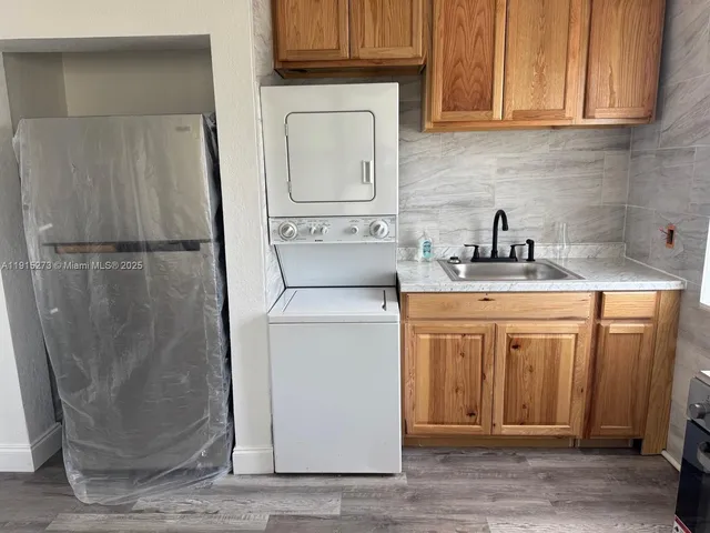 a utility room with a sink washer and dryer