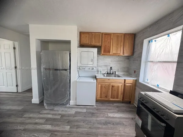 a kitchen with a refrigerator and a sink