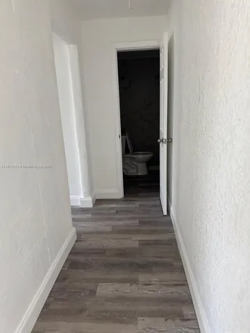 a view of a room with wooden floor