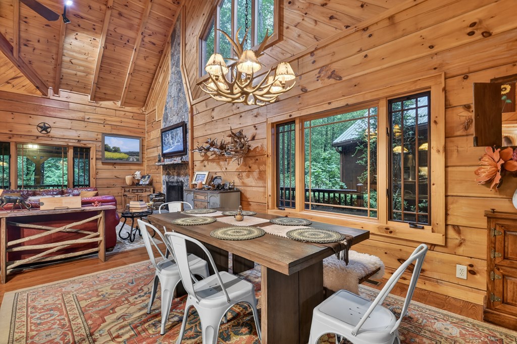 300 River Road Cherry Log, GA 30522 - Photo 28 of 119 a view of a patio with a table and chairs and floor to ceiling window next to a building