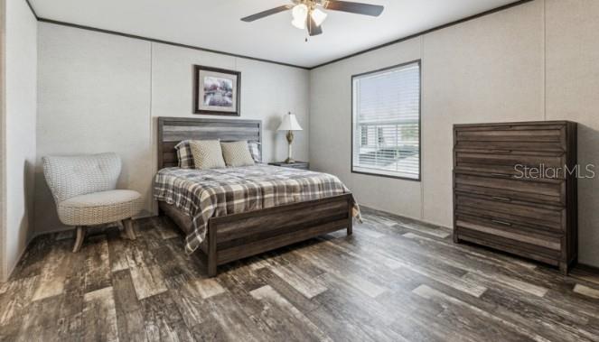 27760 Bermont Road Punta Gorda, FL 33982 - Photo 13 of 18 a bedroom with a bed and a chandelier