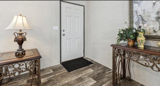 27760 Bermont Road Punta Gorda, FL 33982 - Photo 3 of 18 a view of a hallway with a potted plant