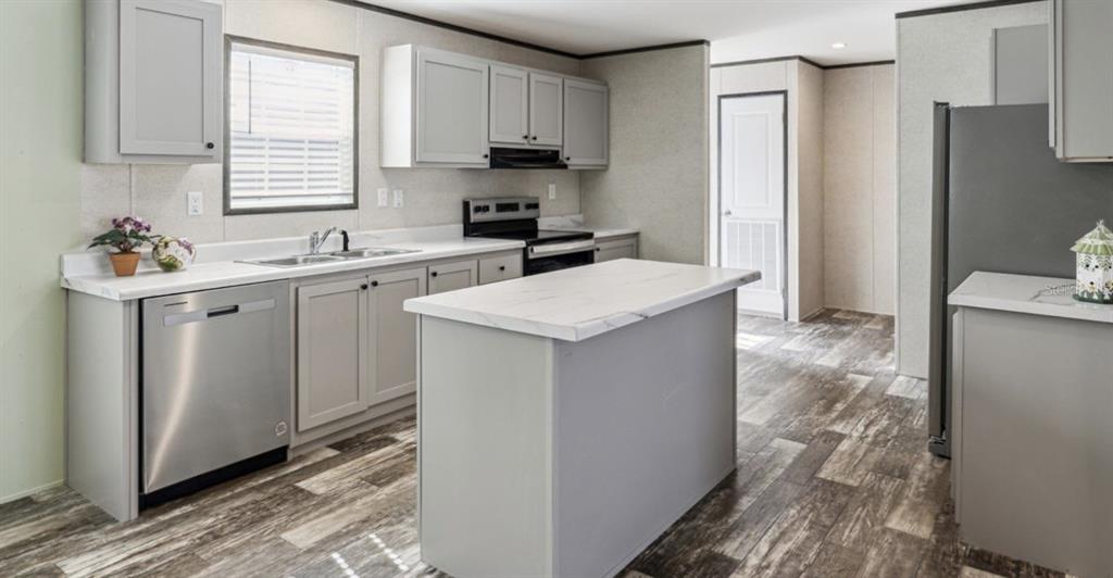 27760 Bermont Road Punta Gorda, FL 33982 - Photo 10 of 18 a kitchen with stainless steel appliances granite countertop a refrigerator sink and white cabinets