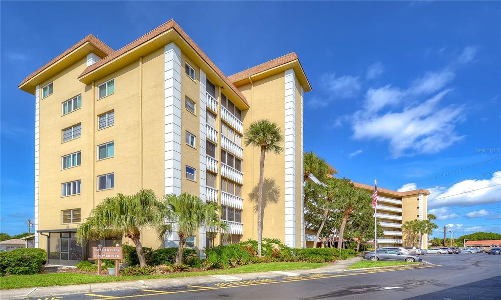 8950 Park Boulevard North, Unit 310 Seminole, FL 33777 - Photo 1 of 28 a view of a tall building next to a road