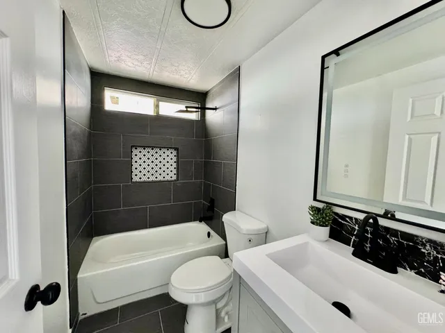 a bathroom with a sink a toilet and a bathtub