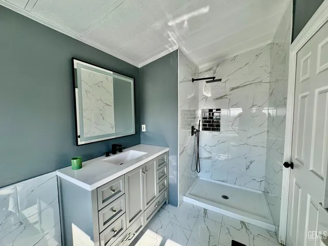 a bathroom with a bathtub sink mirror and toilet