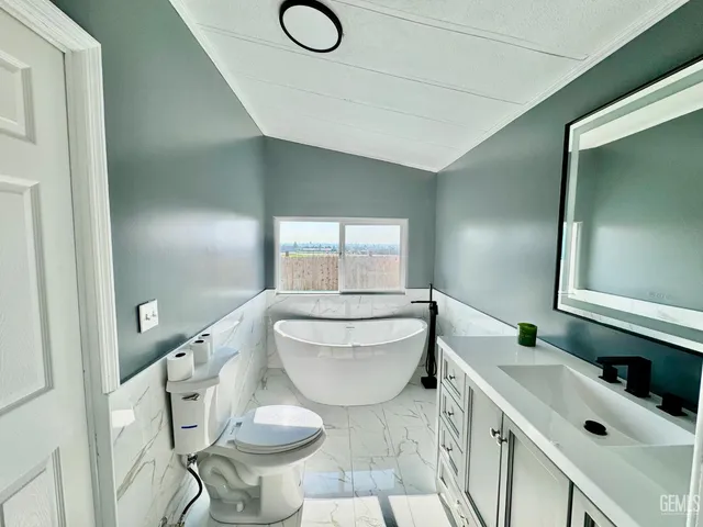 a bathroom with a sink toilet and mirror