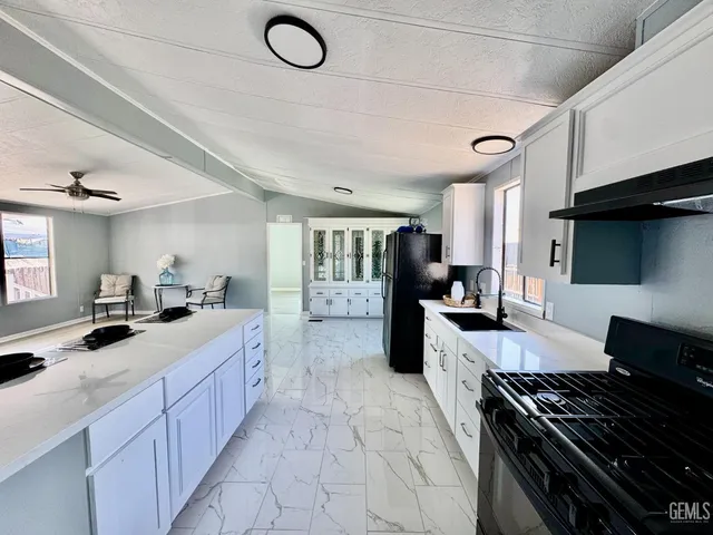 a kitchen with a stove a sink and a refrigerator