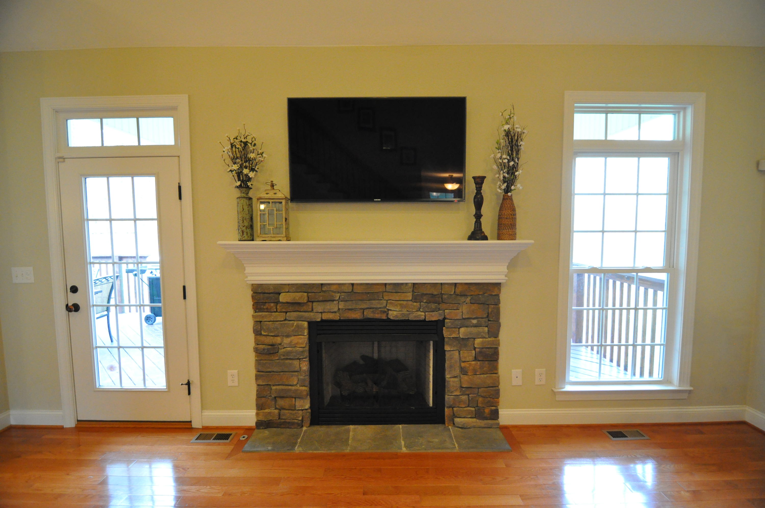 632 Thornblade Way Blue Ridge, VA 24064 - Photo 8 of 41 a living room with a fireplace and a flat screen tv