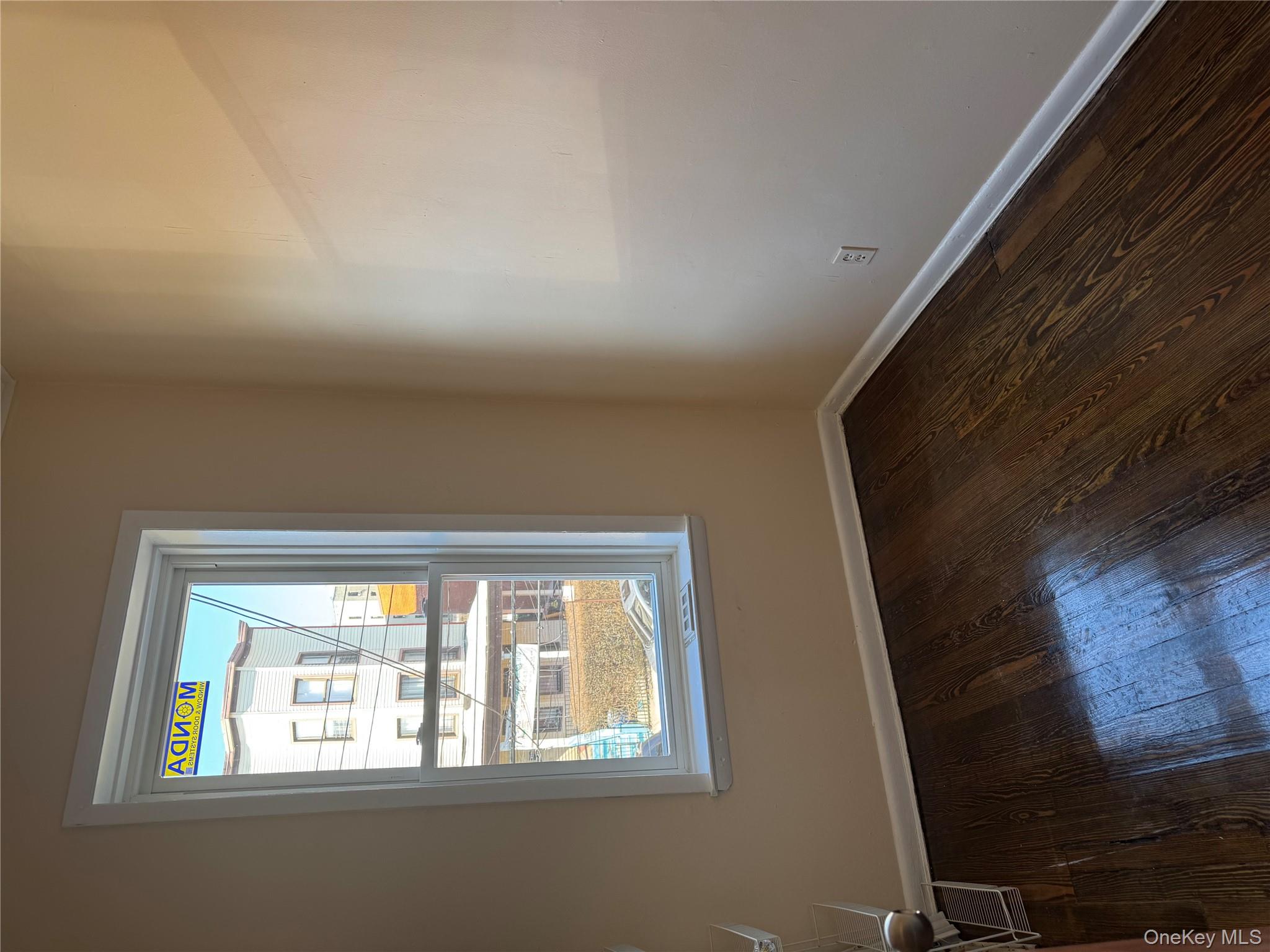 776 Hewitt Place Bronx, NY 10455 - Photo 7 of 20 a view of an empty room with wooden floor and a window