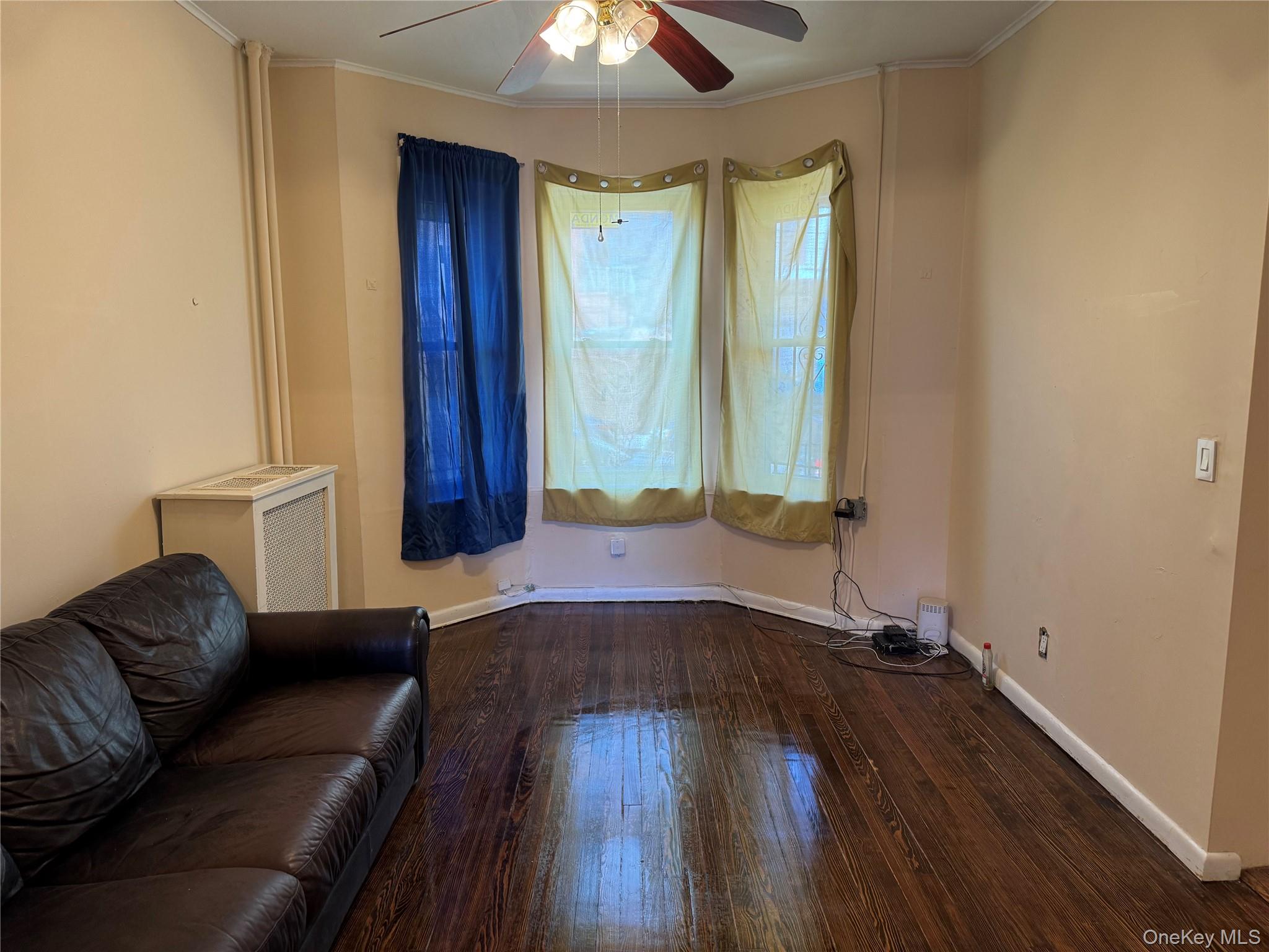 776 Hewitt Place Bronx, NY 10455 - Photo 10 of 20 a living room with a couch and a chandelier