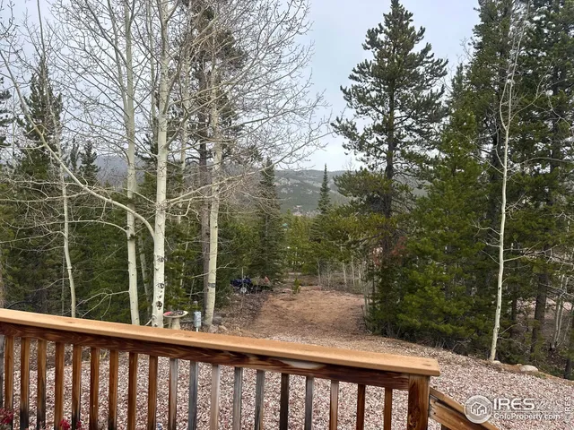 a view of a balcony with yard