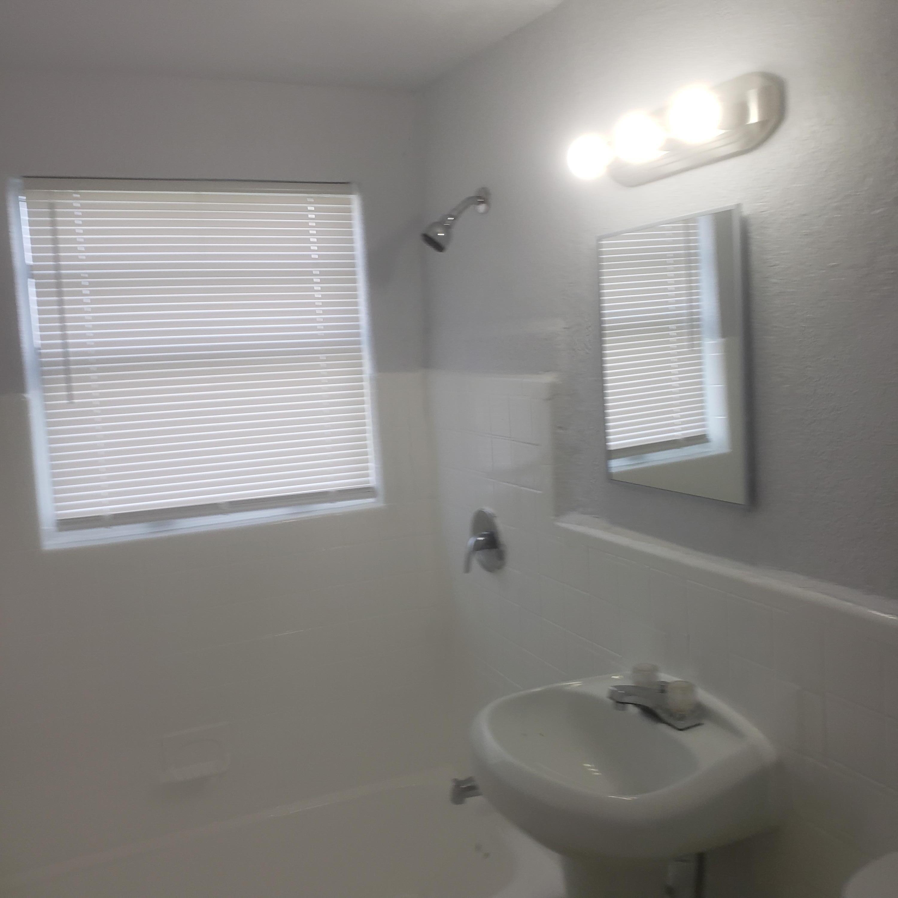 919 6th Street, Unit 15 West Palm Beach, FL 33401 - Photo 18 of 35 a bathroom with a sink a window and a mirror