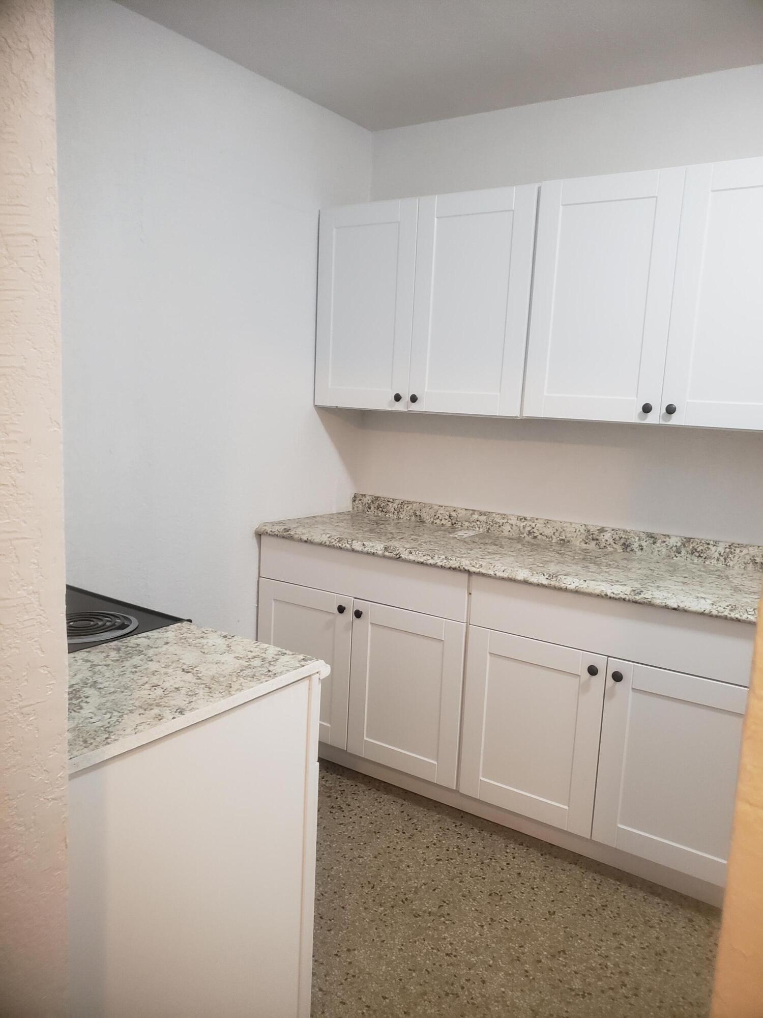 919 6th Street, Unit 15 West Palm Beach, FL 33401 - Photo 21 of 35 a kitchen with granite countertop cabinets sink and stove