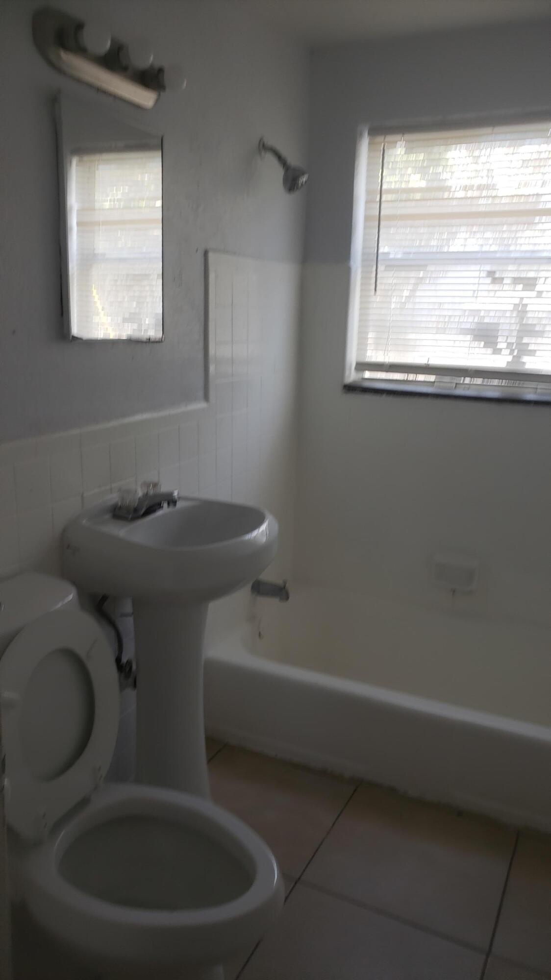 919 6th Street, Unit 15 West Palm Beach, FL 33401 - Photo 28 of 35 a bathroom with a toilet and a window