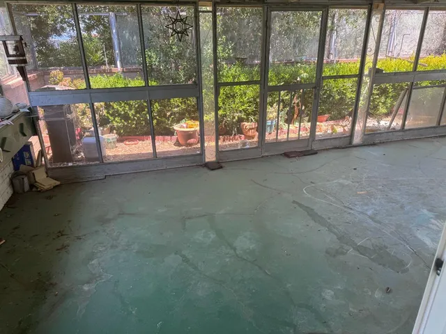 an empty room with large windows