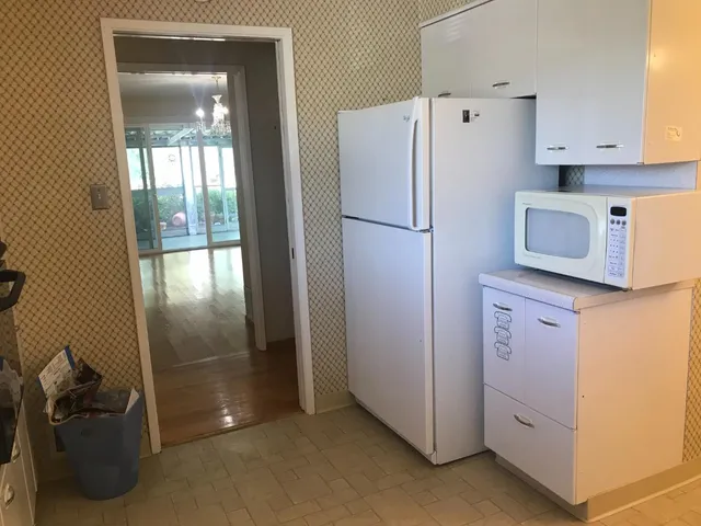 a kitchen with refrigerator and window