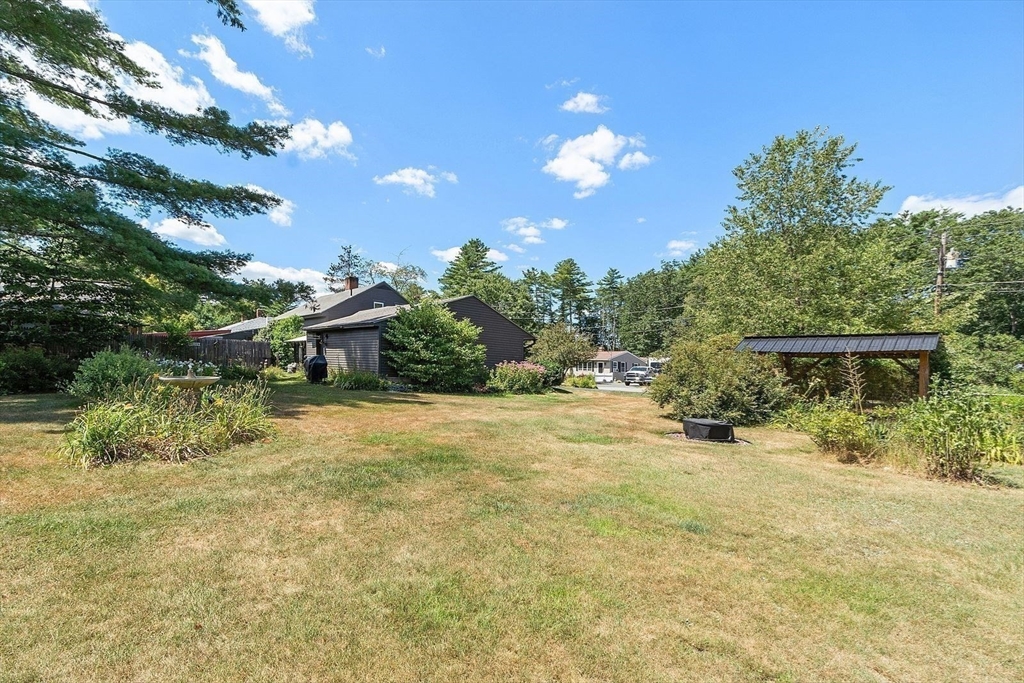 31 Pinedale Road Athol, MA 01331 - Photo 18 of 41 a backyard of a house with table and chairs plants and large trees