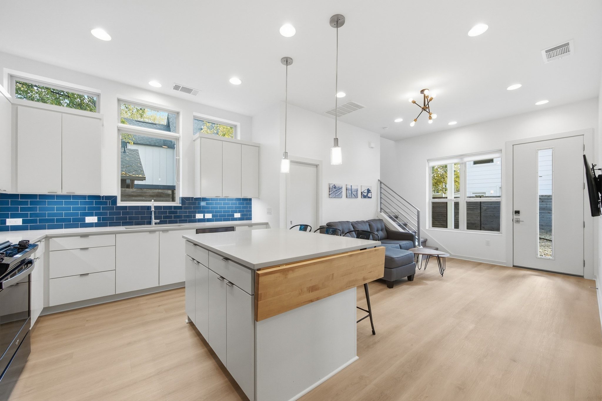 a large kitchen with a large counter top space appliances and cabinets