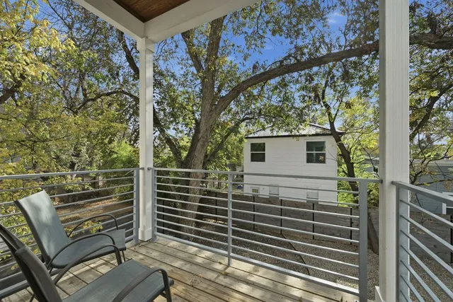 a view of a porch with wooden floor and fence