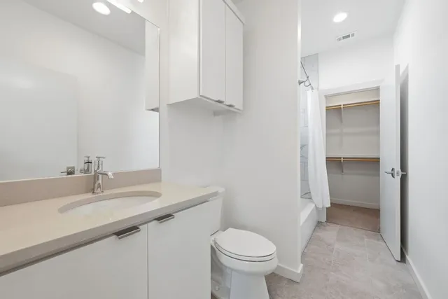 a bathroom with a sink toilet and vanity