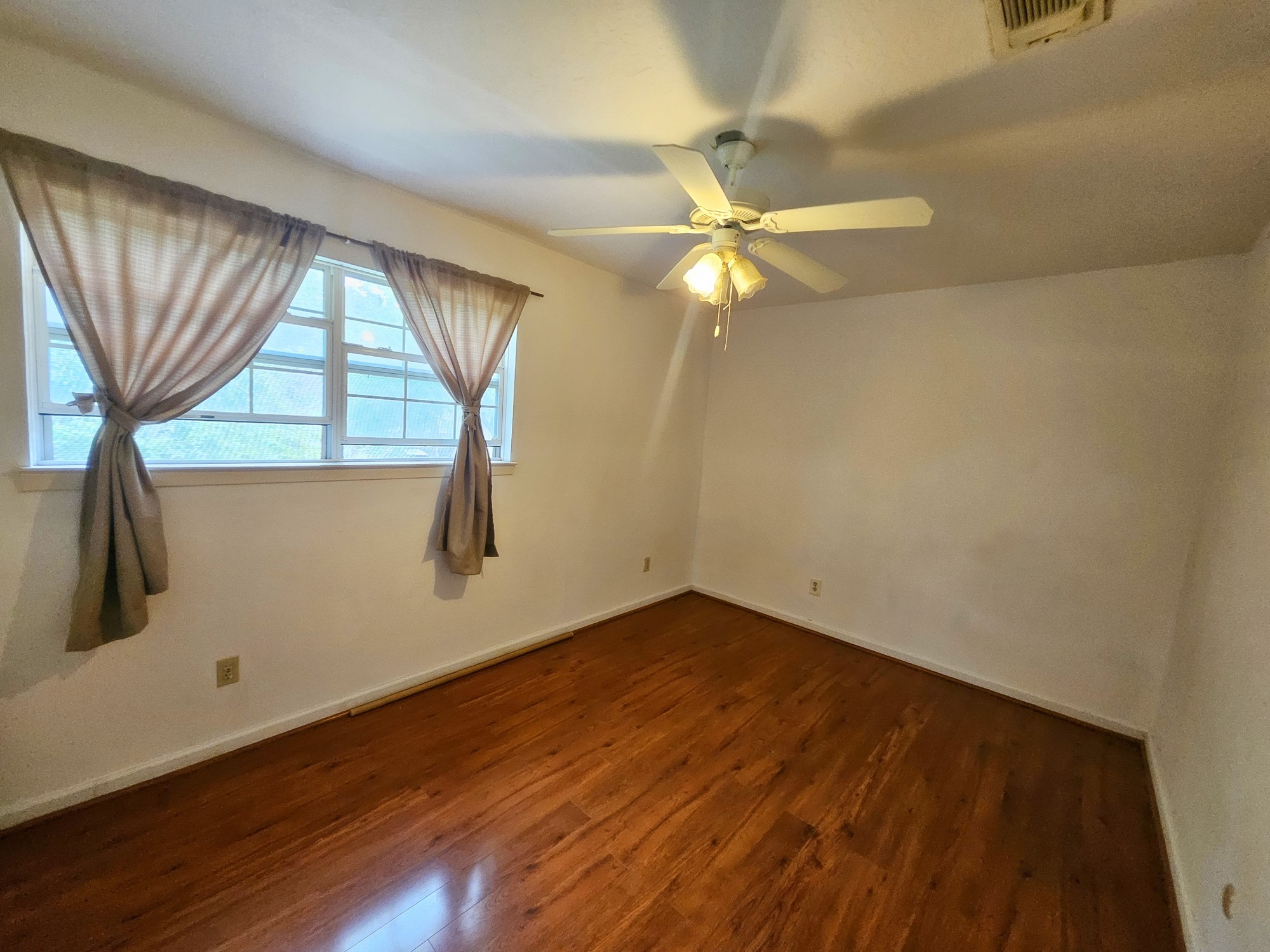 9318 Neff Street Houston, TX 77036 - Photo 7 of 10 wooden floor in an empty room with a window