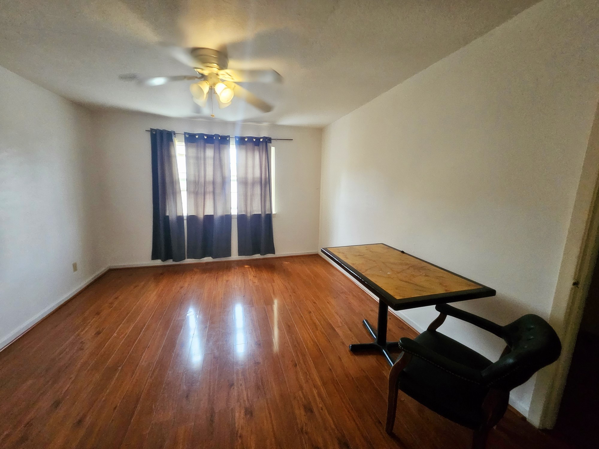 9318 Neff Street Houston, TX 77036 - Photo 8 of 10 a view of an empty room with window and wooden floor