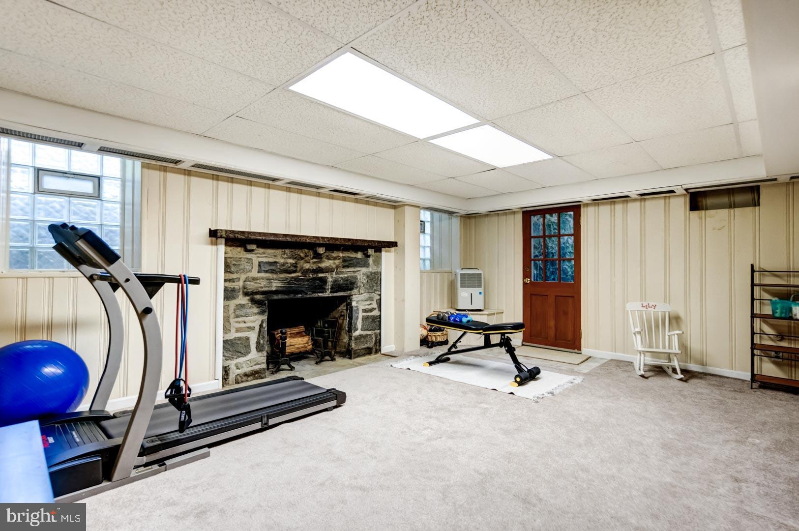 1304 Andover Road Wynnewood, PA 19096 - Photo 27 of 32 Lower Level Family Room with Fireplace and Walk Ou