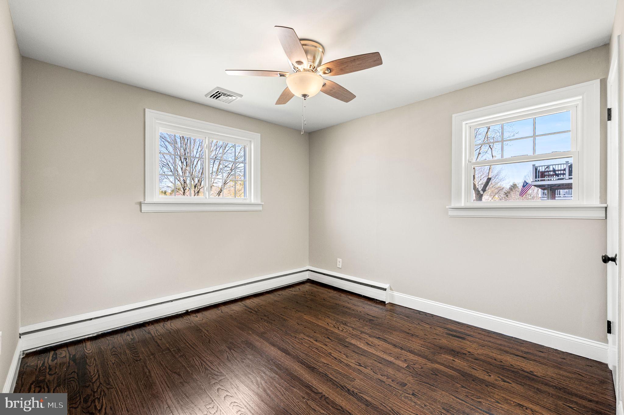 2299 Springhouse Lane Aston, PA 19014 - Photo 15 of 28 a view of an empty room with wooden floor and a ceiling fan