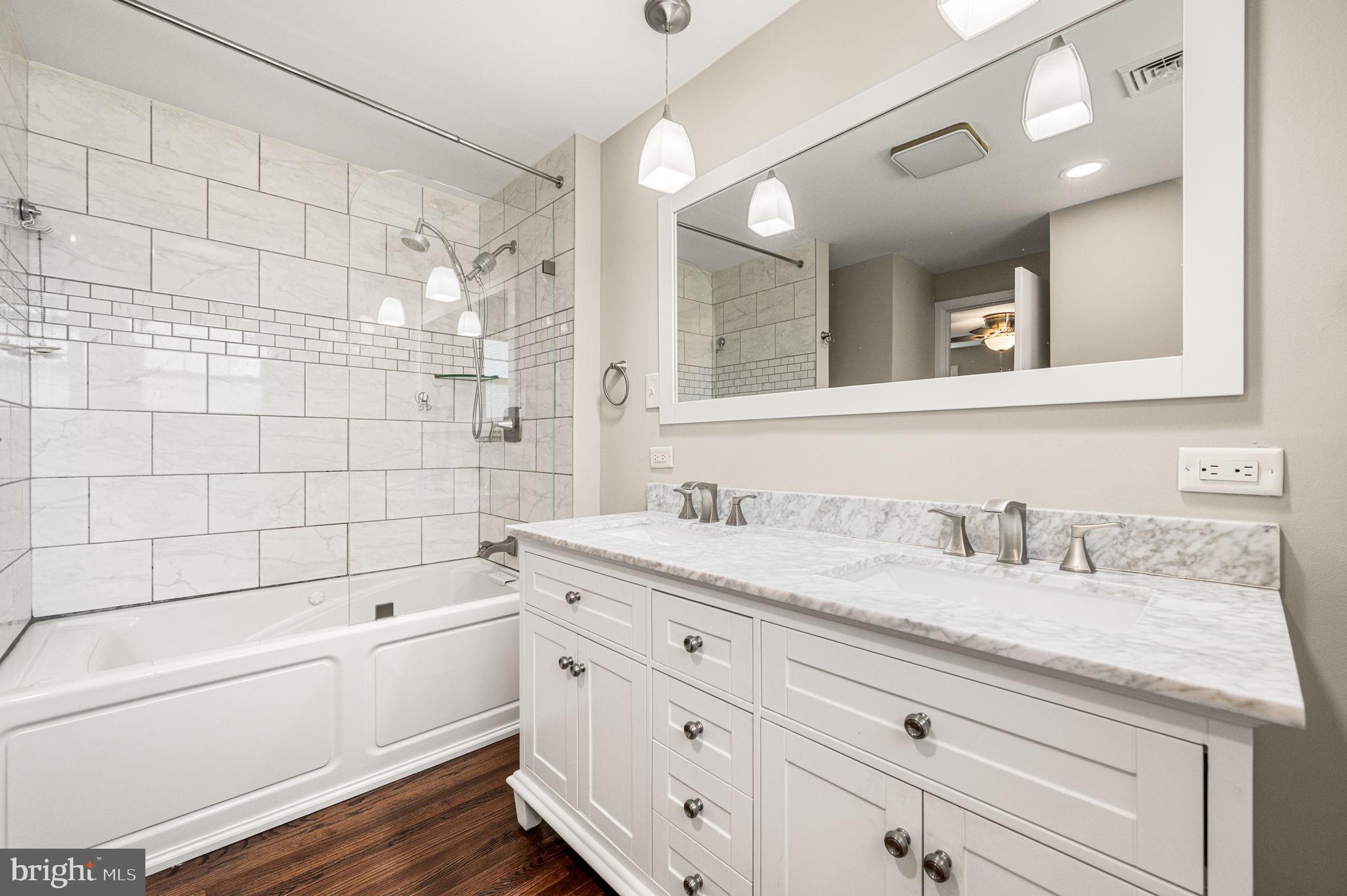 2299 Springhouse Lane Aston, PA 19014 - Photo 18 of 28 a bathroom with a granite countertop sink mirror bathtub and shower