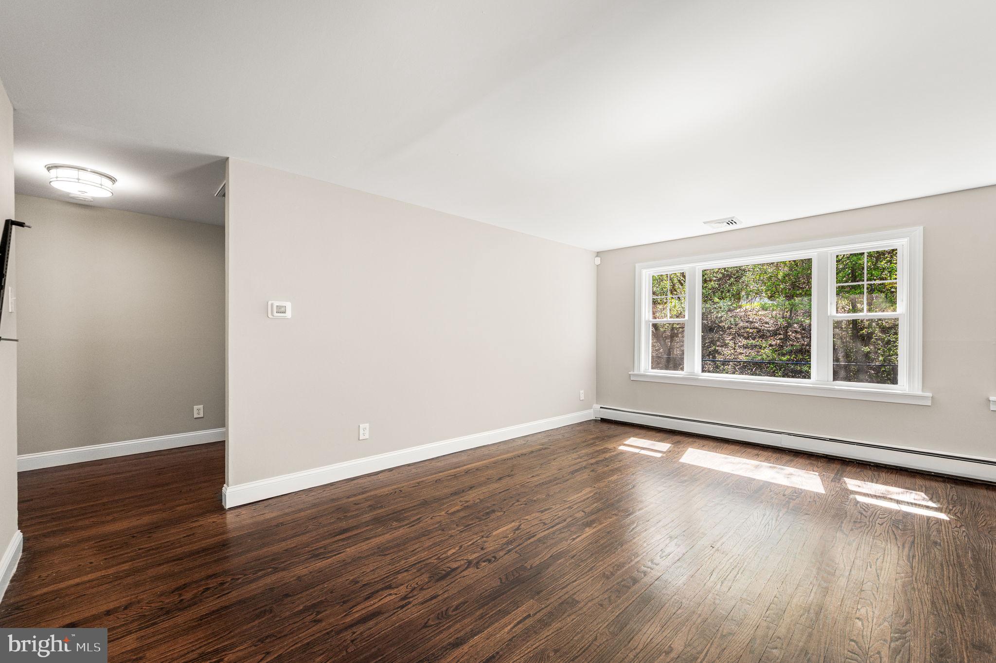 2299 Springhouse Lane Aston, PA 19014 - Photo 8 of 28 a view of an empty room with wooden floor and a window