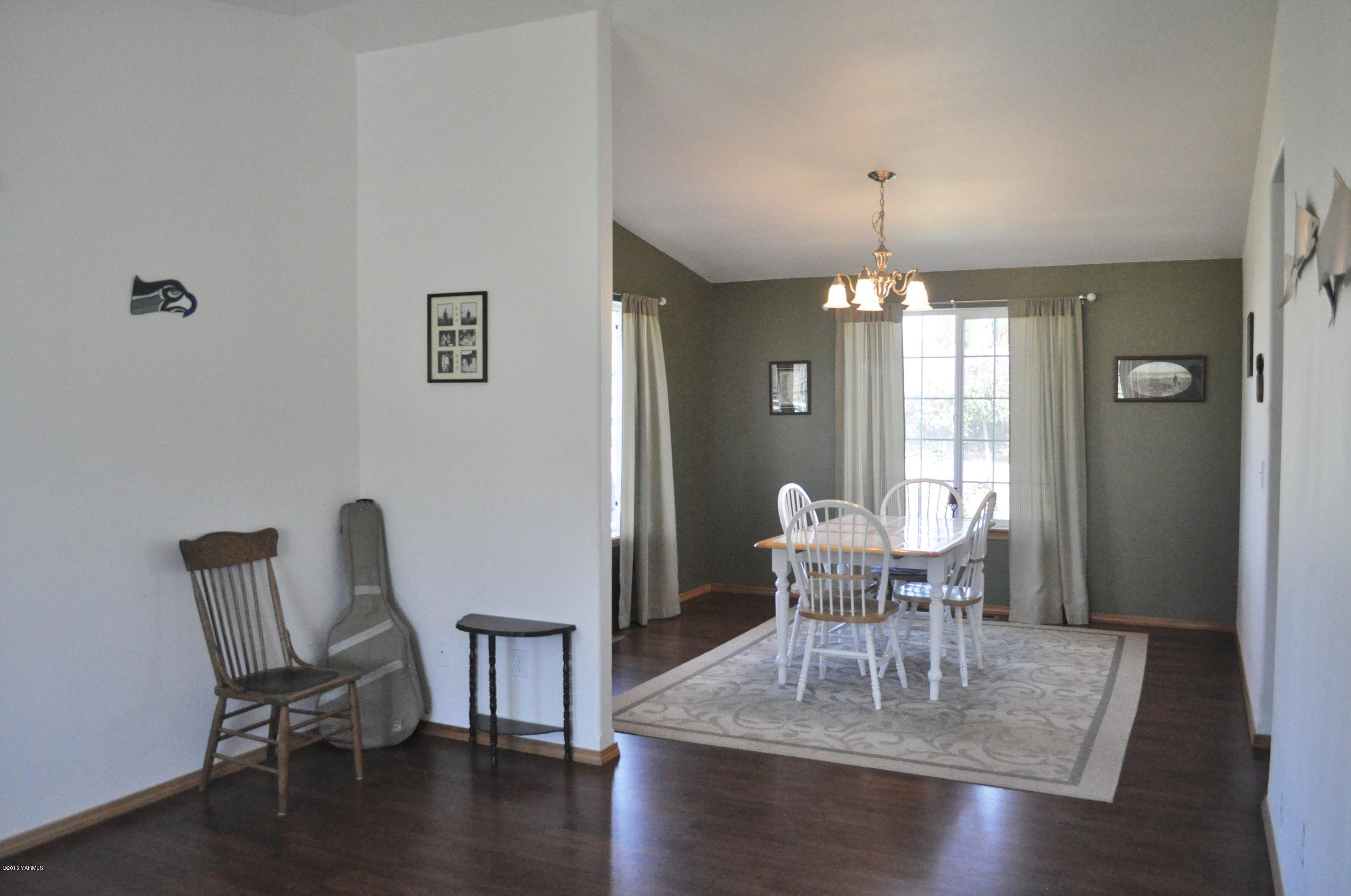 5011 Gamache Road Moxee, WA 98936 - Photo 8 of 26 a dining room with furniture window and wooden floor