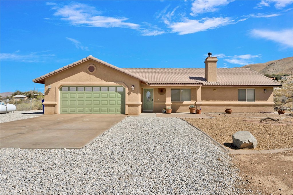 9191 Nambe Road Apple Valley, CA 92308 - Photo 1 of 1 a front view of a house with a yard