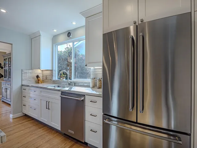 a kitchen with stainless steel appliances a refrigerator and a sink