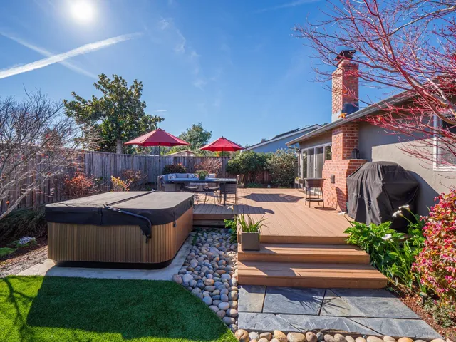 a front view of house and yard with swimming pool and fire pit