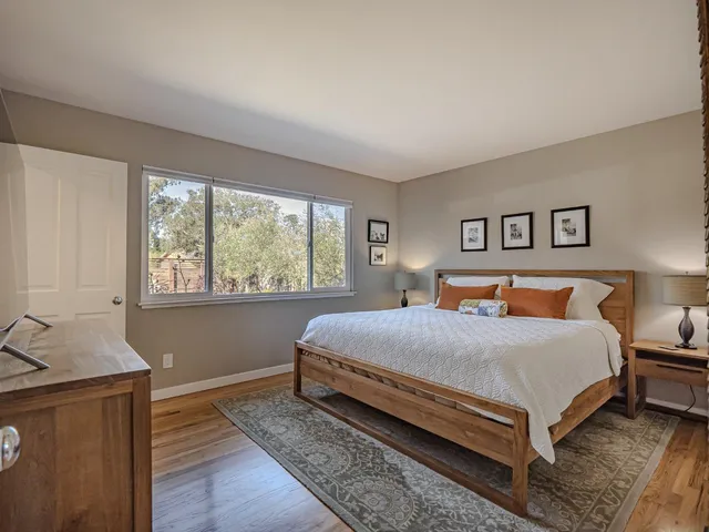 a bedroom with a large bed and a window