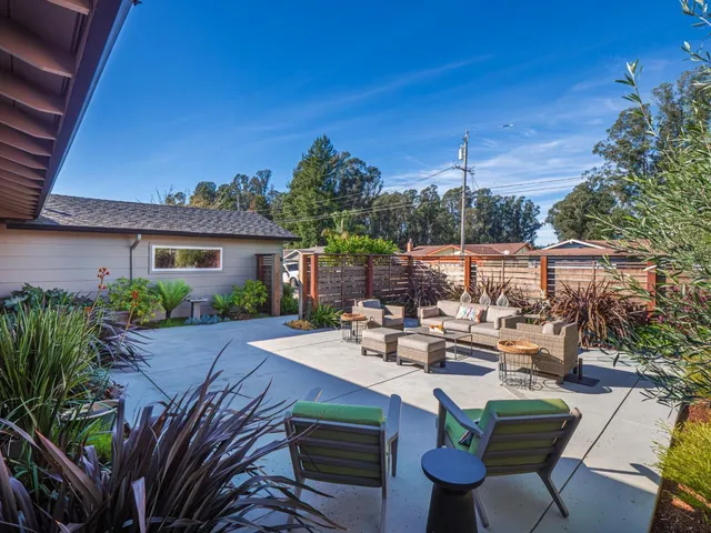a view of a patio with table and chairs and potted plants