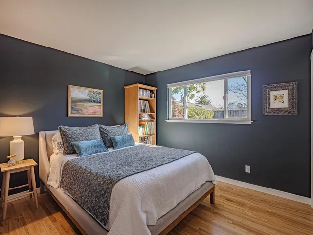 a bedroom with a large bed and a window