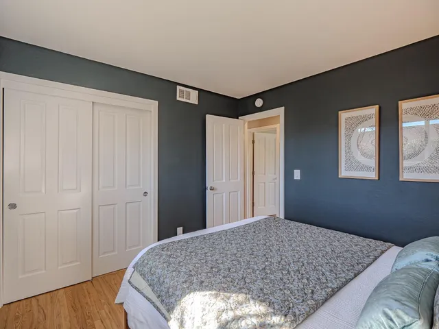 a bedroom with a bed and a window