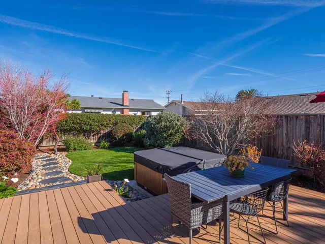a view of a patio with table and chairs and potted plants