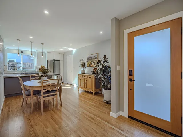 a view of a dining room with furniture and wooden floor