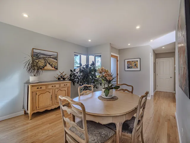 a view of a dining room with furniture and wooden floor