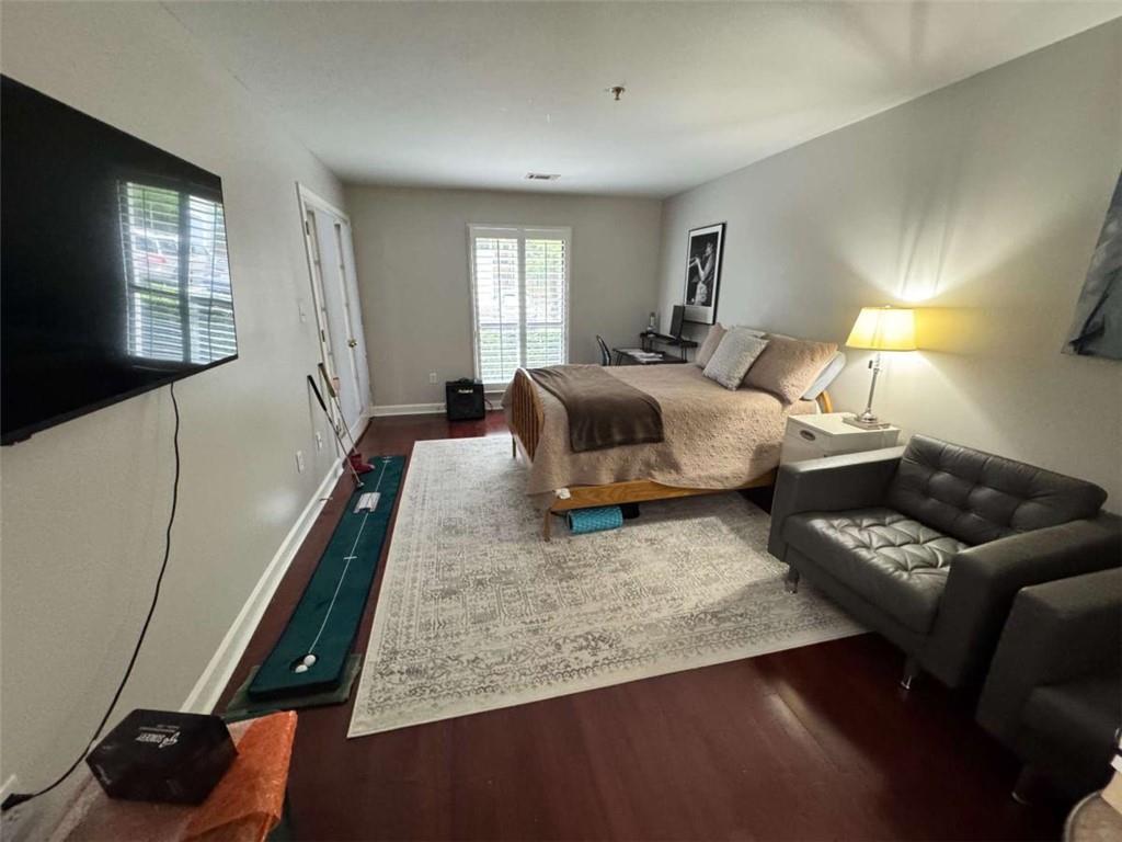 3201 Lenox Road Northeast, Unit 2 Atlanta, GA 30324 - Photo 19 of 39 a bedroom with a bed and wooden floor