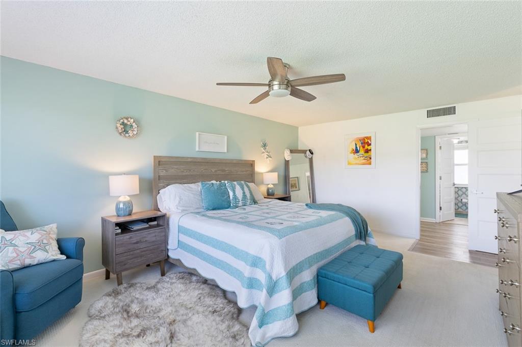 159 Quails Nest Road, Unit 1084 Naples, FL 34112 - Photo 15 of 21 a bedroom with a bed and ceiling fan