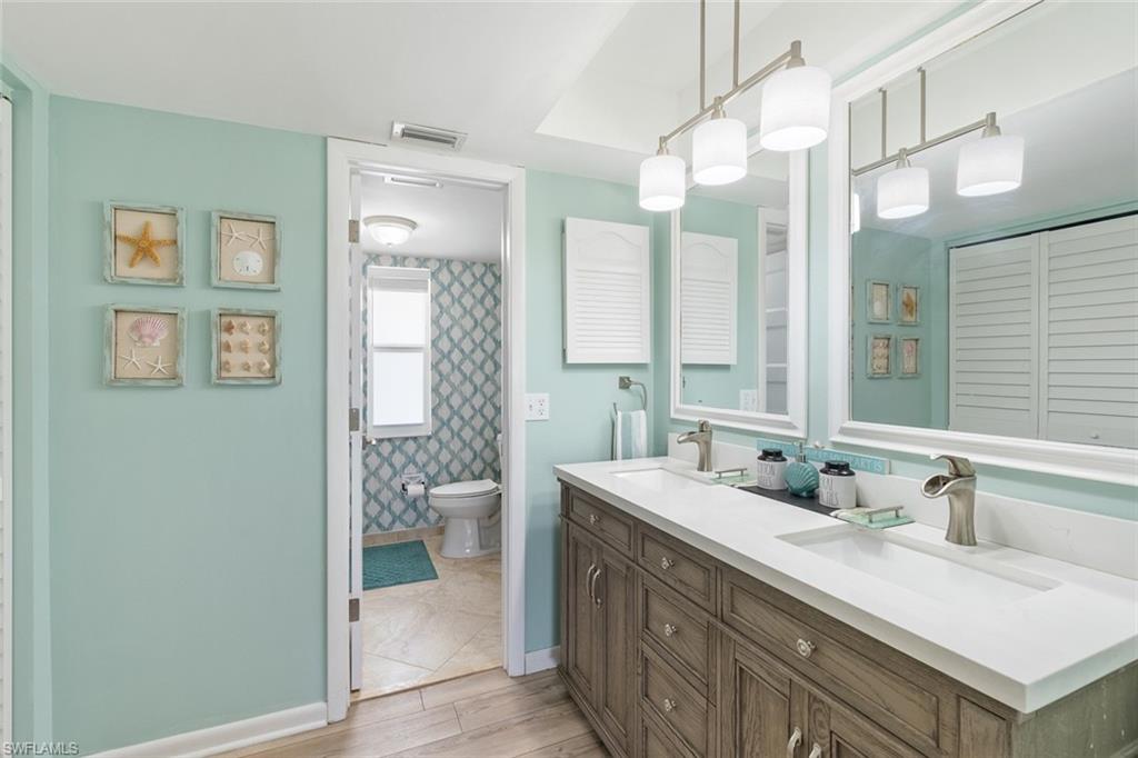 159 Quails Nest Road, Unit 1084 Naples, FL 34112 - Photo 16 of 21 a bathroom with a sink double vanity and a shower