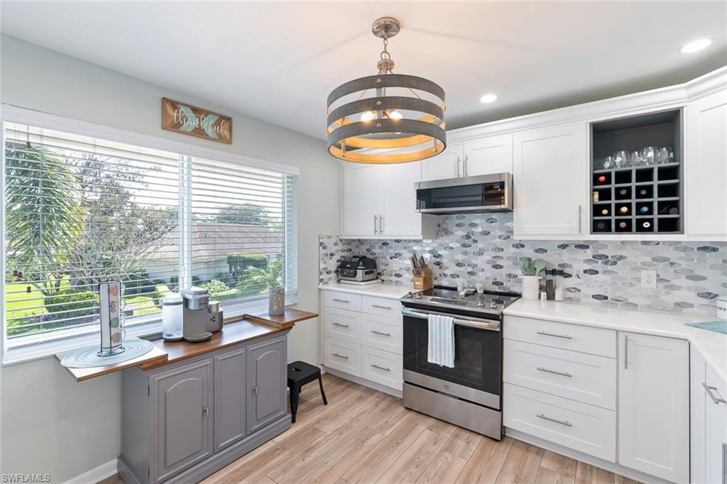 159 Quails Nest Road, Unit 1084 Naples, FL 34112 - Photo 2 of 21 a kitchen with a stove a sink and a window