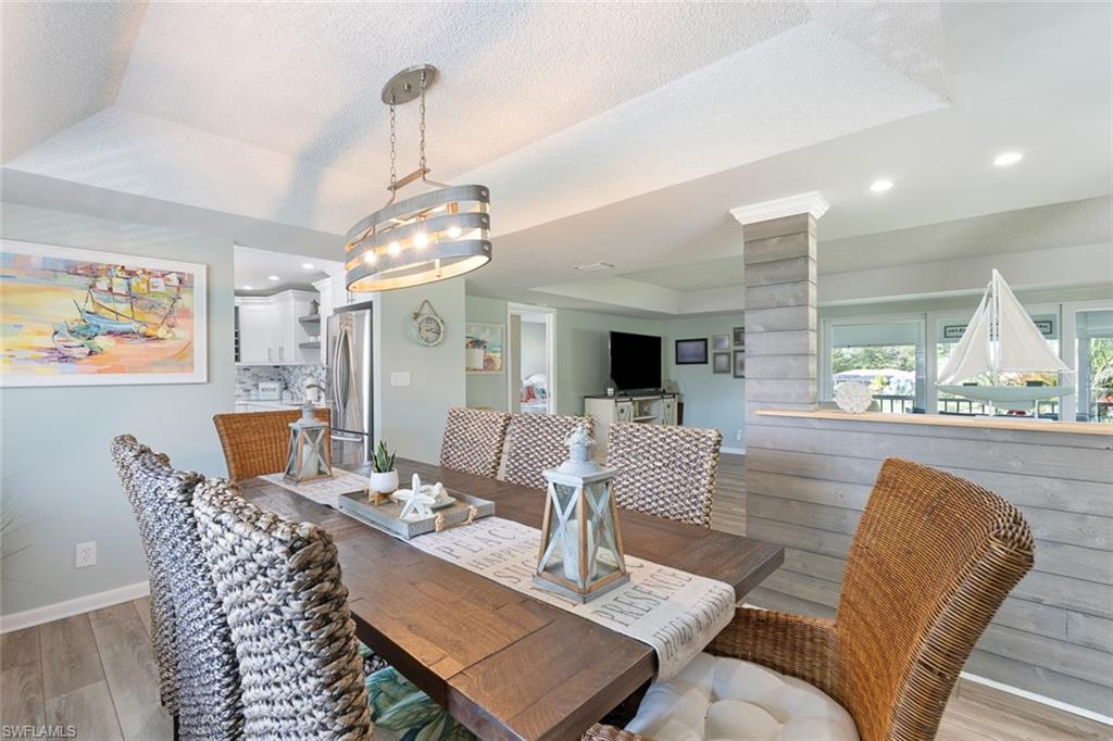 159 Quails Nest Road, Unit 1084 Naples, FL 34112 - Photo 21 of 21 a living room with furniture and a large window